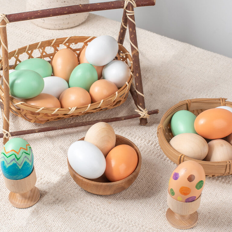 Children painting wooden Easter eggs for DIY holiday craft activity
