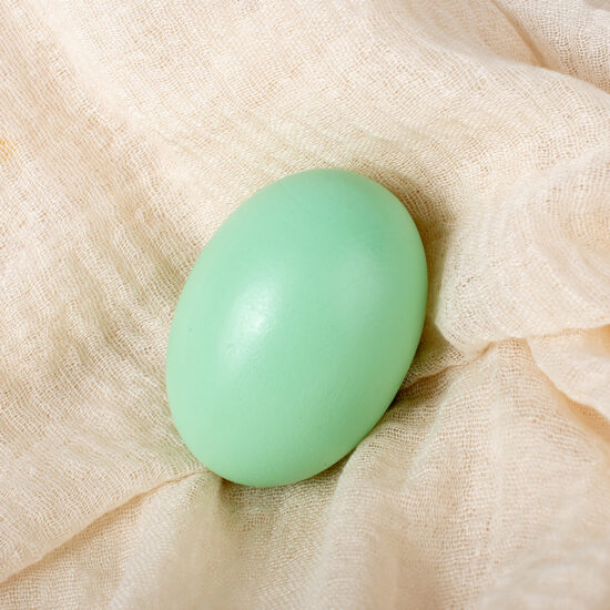 Children painting wooden Easter eggs for DIY holiday craft activity